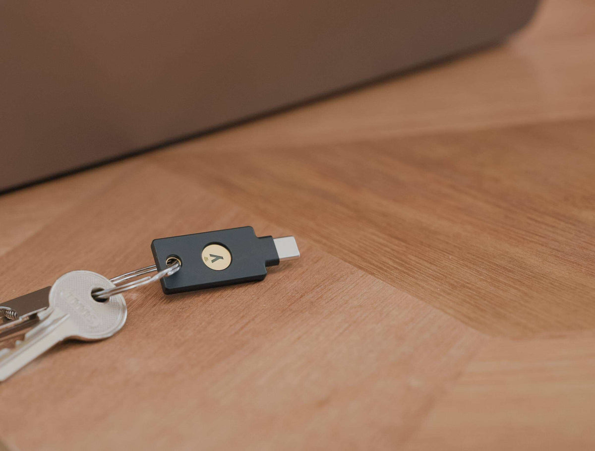 木製のデスクに置かれた、鍵束に付いたYubiKey